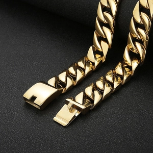 Detailed macro shot of a golden stainless steel Cuban link chain with a secure box clasp