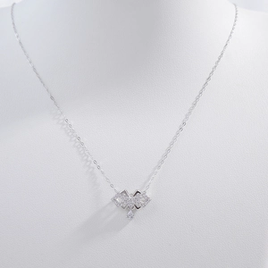 Detail of S925 silver bow pendant with zircons and drop-shaped crystal on O-chain