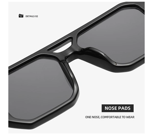 Detail view of ergonomic one-piece nose pads on black double-bridge square sunglasses