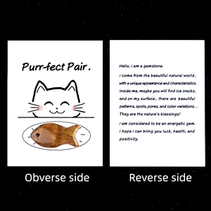 Fish-shaped tiger eye gemstone with cat-themed healing card showing obverse and reverse