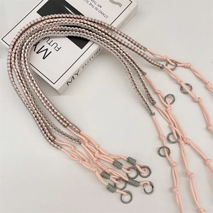 Close-up of pink and grey woven shoulder strap with silver O-ring metal buckles