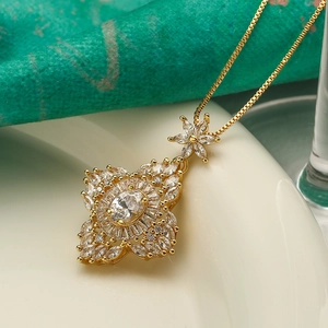 Macro shot of gold pendant with oval zircon and marquise-cut stones in vintage design