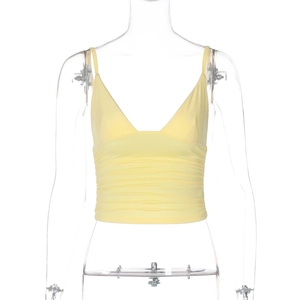 Detail of yellow V-neck crop top camisole featuring stylish front pleats and soft texture