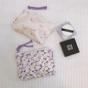 Close-up of floral cotton pouches with zipper and woven simple wish side label