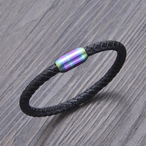 Detail of black woven leather bracelet featuring a rainbow gradient magnetic metal clasp