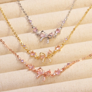 Bowknot necklaces in silver, gold, and rose gold with pink heart stones and zircon