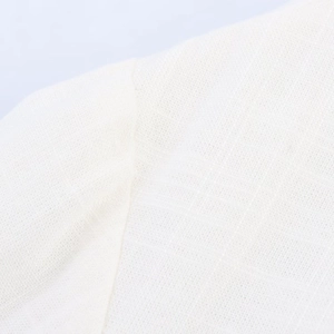 Close-up of white woven cotton-linen fabric texture with detailed stitching and seam craft
