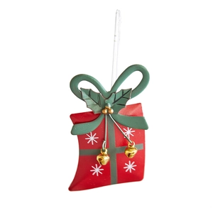 Red Christmas iron gift box ornament with green bow and gold bells on white background