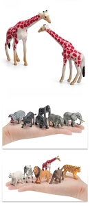 Miniature wild animal toys showing giraffe and tiger actual size held in hand
