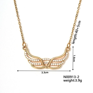 Detail view of gold wing pendant necklace with cubic zirconia and size specifications