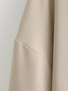 Close-up of beige ribbed twill woven fabric showing detailed jacket texture and quality