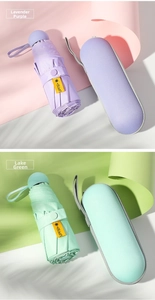 Compact UPF50+ folding sun umbrellas in lavender and teal with capsule storage cases