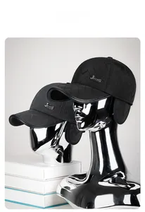 Close-up of winter quilted baseball cap with ear flaps and metal jeans logo detail