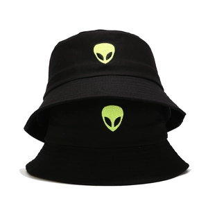 Detailed close-up of neon green alien embroidery on premium black cotton bucket hats