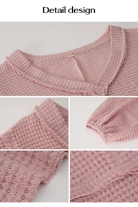 Detail view of pink waffle knit top showing V-neck, cuffs and hem stitching texture