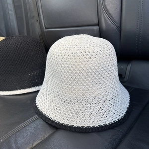 Detail of hollow knit texture on two contrasting color foldable sun bucket hats
