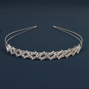 Detail of silver double-layered rhinestone crown headband with sparkling diamond patterns