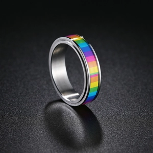 Macro view of rotating rainbow stainless steel stress relief ring with polished edges