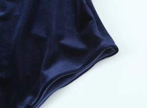 Detail of dark blue velvet fabric texture showing soft luster and fine premium quality