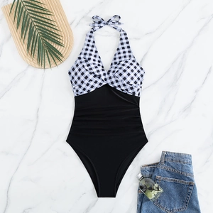Flat lay of a black and white gingham one-piece swimsuit with ruched slimming tummy control