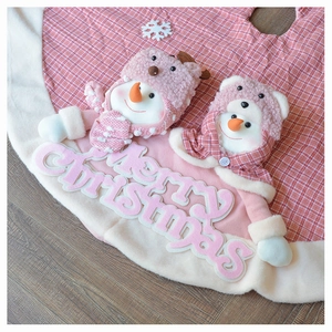 Detail of plush Christmas tree skirt with 3D snowman and red plaid fabric design
