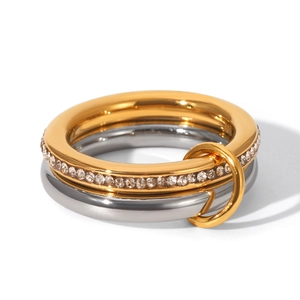 Detailed macro view of interlocking gold and silver rings with pave set white zircons