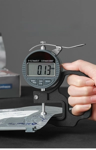 Digital thickness gauge measuring a 0.13mm food-grade aluminum foil bag precisely