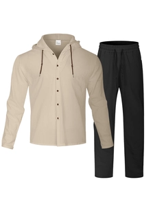 Detail view of beige linen hooded shirt and black trousers set with fabric care label