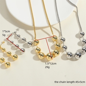 Detail view of 14K gold and silver ball jewelry set with size and weight dimensions