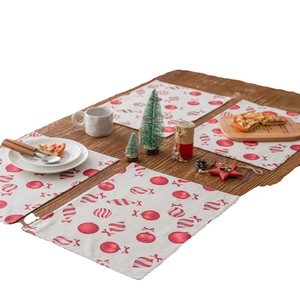 Christmas table mats with red candy cane prints on cotton linen for festive holiday decor