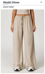 Detailed view of linen color wide-leg pants with elastic drawstring waist and drape