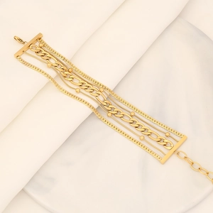 Close-up of golden multi-layer beaded bracelet with mixed chain textures and marble display