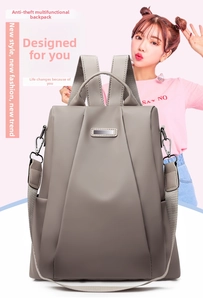 Detail of khaki anti-theft oxford backpack with wide straps and metal buckles for travel