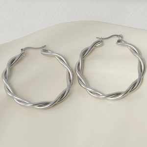 Macro detail of silver twisted wire hoop earrings in 304 stainless steel texture