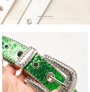 Close-up of a trendy green glitter belt with silver rhinestone buckle and crystal accents