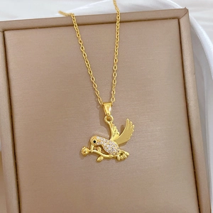 Detail view of swallow and rose gold necklace with micro-pave cubic zirconia crystals