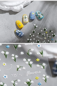 Detailed view of 5D embossed nail stickers with lily of the valley and butterfly designs