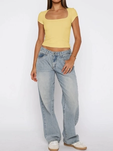 Close-up of yellow square neck short sleeve crop top paired with light blue washed jeans