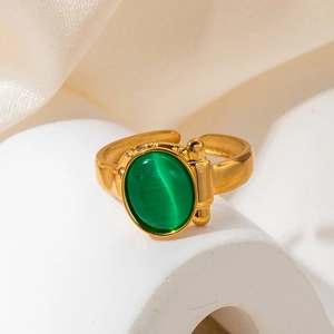 Detail of vintage gold ring featuring a green oval opal and unique spherical accents