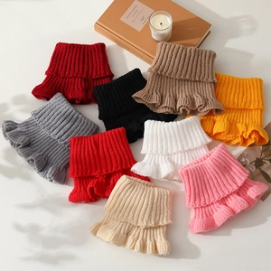 Chic ribbed knit neck warmer with ruffle trim available in various seasonal colors
