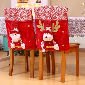 Detail of Christmas chair covers featuring 3D Santa and Reindeer plush decorations