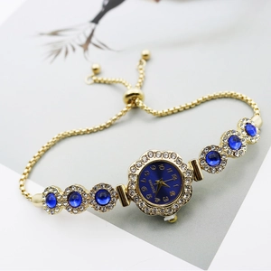 Detailed macro of gold quartz bracelet watch with blue dial and adjustable closure