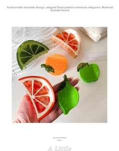 Macro detail of high-quality acetate hair claw clips in realistic fruit slice designs