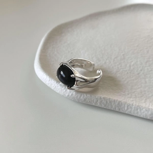 Detail of s925 silver ring with liquid metal texture and large oval black onyx stone