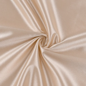 Close-up of champagne gold silk satin fabric with fine vertical texture and spiral pleats