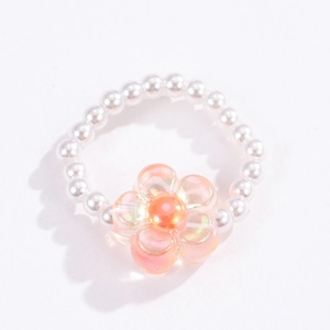 Close-up of bohemian beaded ring featuring white pearls and a pink floral glass bead