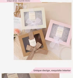 Detailed view of rectangular gift boxes with PVC window, ribbons and soft paper filling