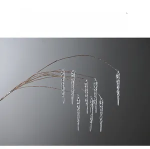 Detailed view of clear acrylic Christmas icicle ornaments with elegant gold wire supports