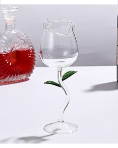Detail of rose-shaped wine glass with green leaf stem made of high borosilicate glass