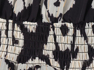 Detail of smocking waist with black and white print and subtle gold metallic thread